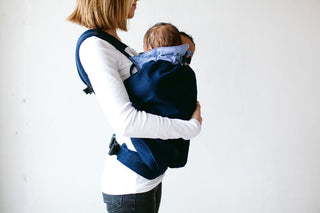 Woman carrying twins in Weego TWINS baby carrier. Side View.